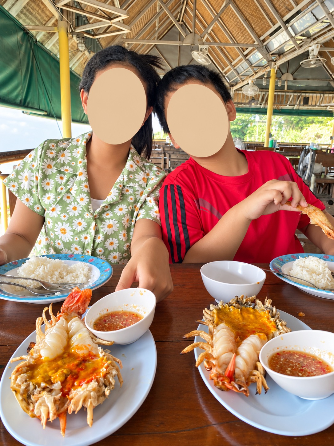 Family meal with grilled river prawns, rice and dipping sauce