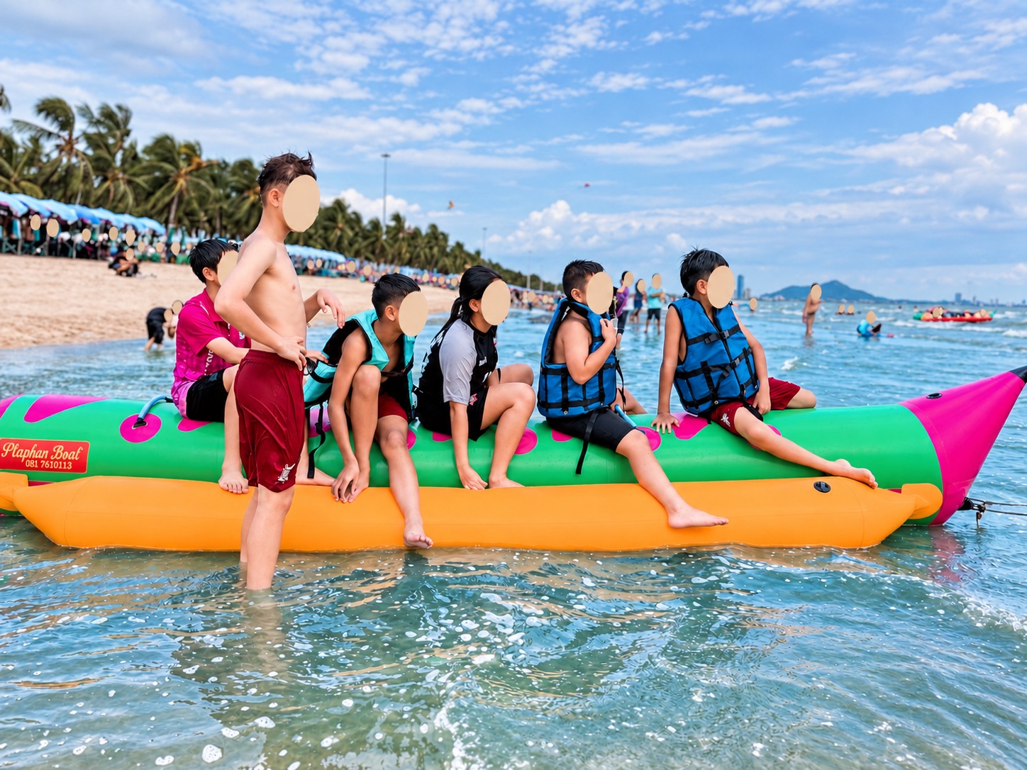 Family on a banana boat at Bang Saen Beach with faces covered