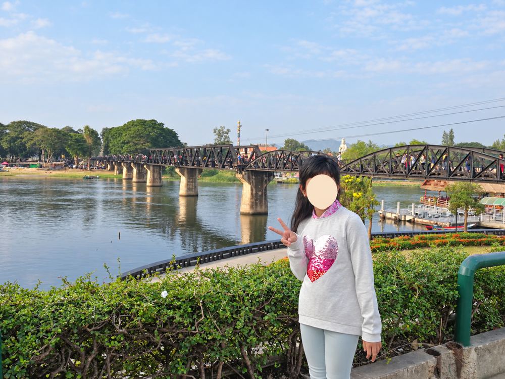 Kanchanaburi travel guide: My daughter beside the River Kwai bridge