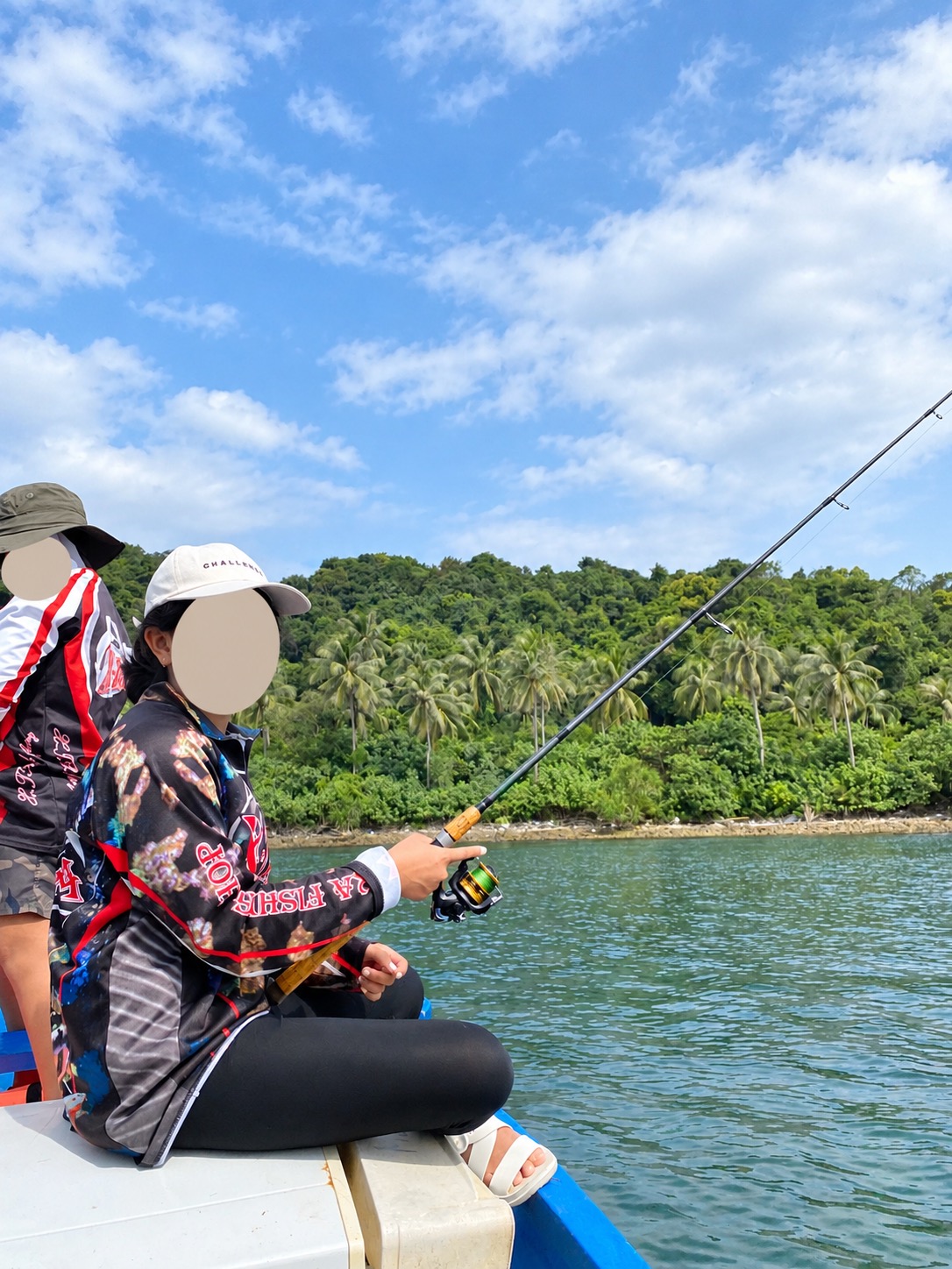 Child fishing from a boat with face covered