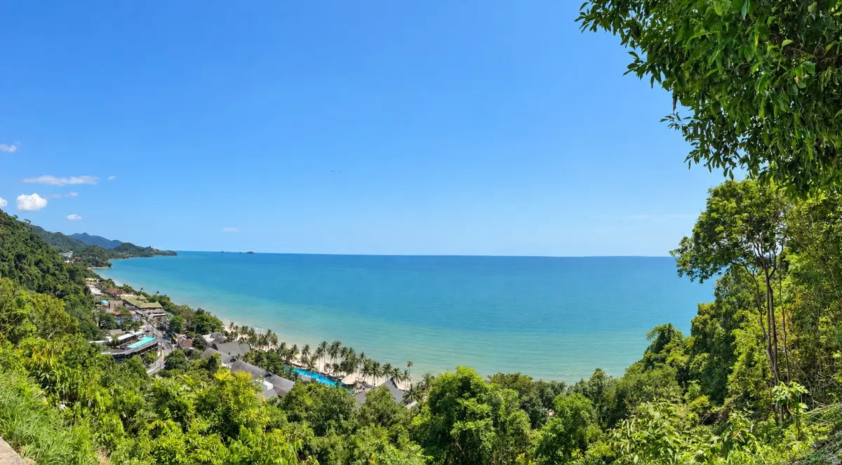 Koh Chang coast with forested hills and sandy beach
