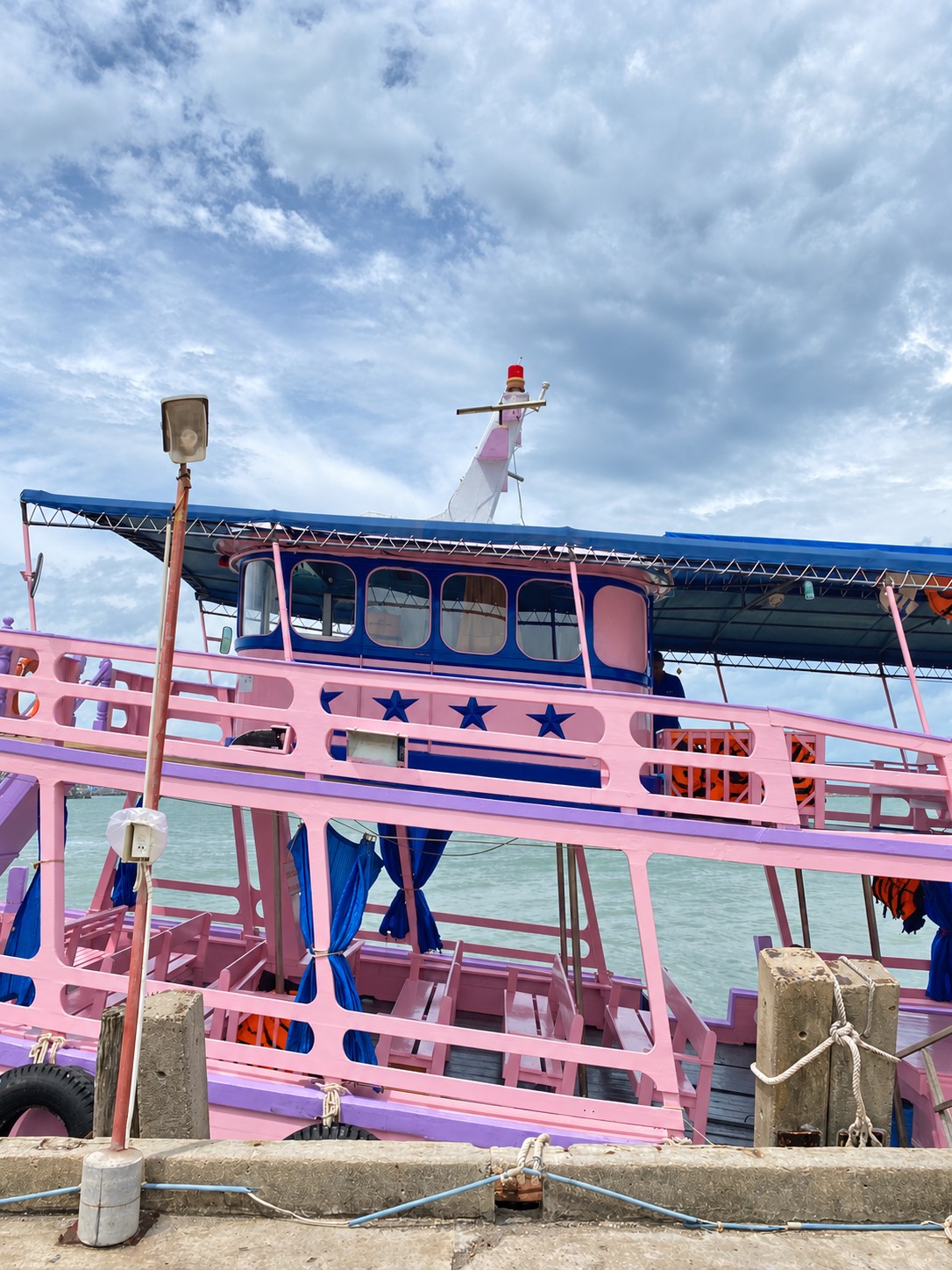 Pink passenger ferry alongside the pier