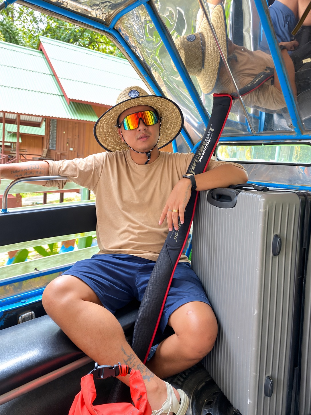 Passenger and luggage inside a blue songthaew on Koh Samet